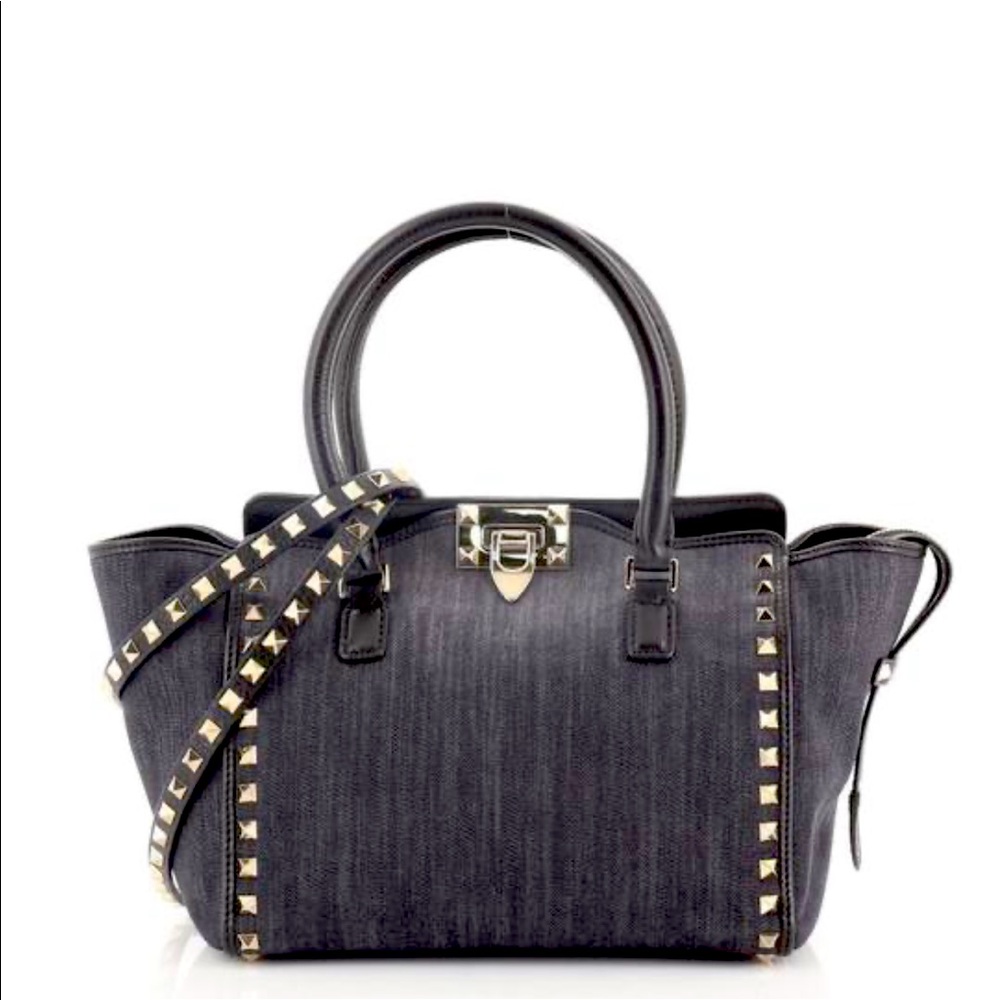 Denim valentino rockstud bag, with gold hardware and black leather trim.